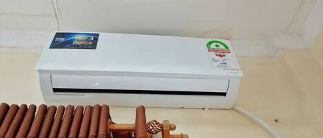 A white air conditioning unit with a sticker indicating it is a top 3 energy saver in Europe.