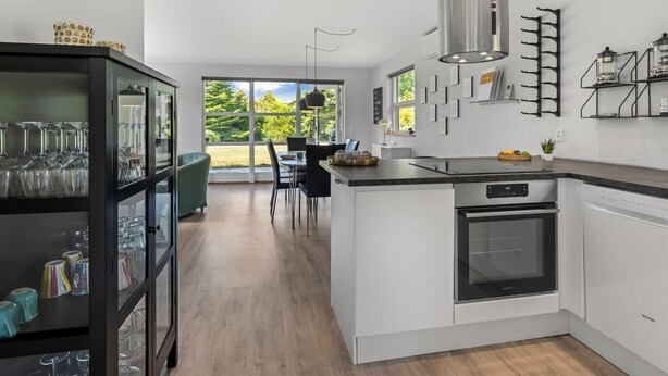 A modern kitchen with a central island, a built-in oven, and a stainless steel range hood. - "Agneta" - 1km from the sea by Interhome (Væggerløse)