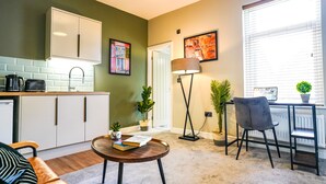 A compact living space with a kitchenette, a dining area, and a workspace. - The City Centre Studios (Peterborough)
