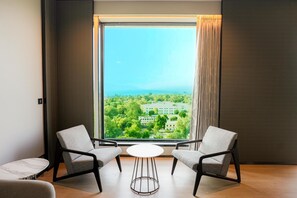 Presidential Suite | Living room | 50-inch LCD TV with digital channels, books - Radisson Hotel Jamshedpur (Jamshedpur)