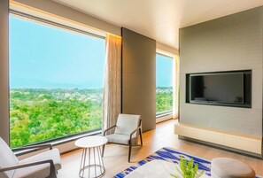 Presidential Suite | Living room | 50-inch LCD TV with digital channels, books - Radisson Hotel Jamshedpur (Jamshedpur)