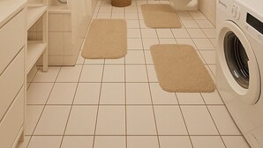 Une salle de bain moderne équipée d’une douche, de toilettes, d’un lavabo et d’un lave-linge.