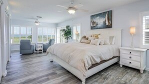 A spacious bedroom with a large bed, a ceiling fan, a desk, and a chair. - Welcome to “Salty Dog” - named after the old sea captain, this beautiful house directly on the Atlantic Ocean is decorated throughout with a nautical theme. With the breathtaking view of the ocean out your back door you will feel as though you are ac (Indialantic)