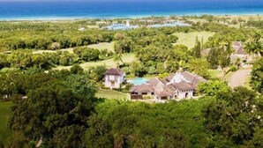A coastal property with multiple houses, a swimming pool, and a view of the ocean. - Half Hill 1BR (Montego Bay)