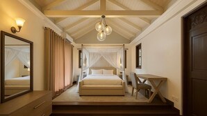 A bedroom with a bed, bedside table, chair, and a large mirror. - Colonial type 4-bedroom villa in Colombo with WiFi, AC (Colombo)