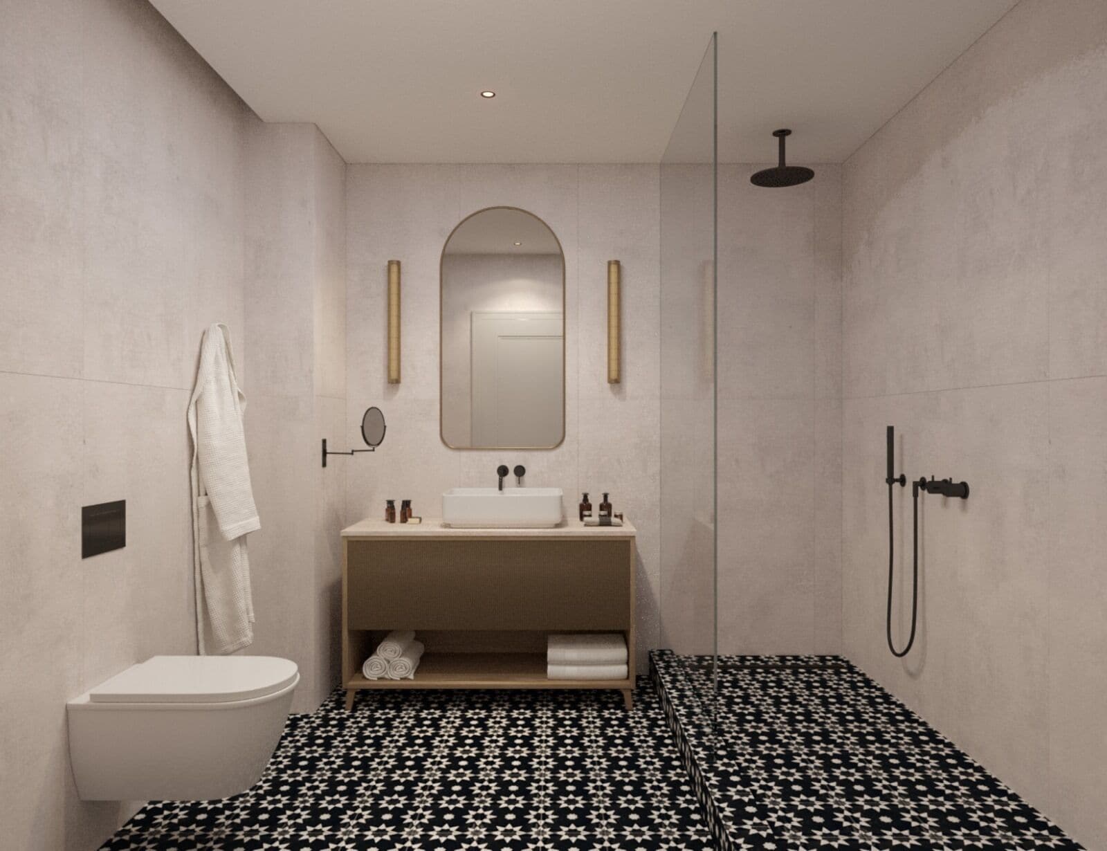 Un baño moderno con inodoro blanco, un lavabo con espejo superior, una ducha con cabezal de ducha manual y un piso estampado.