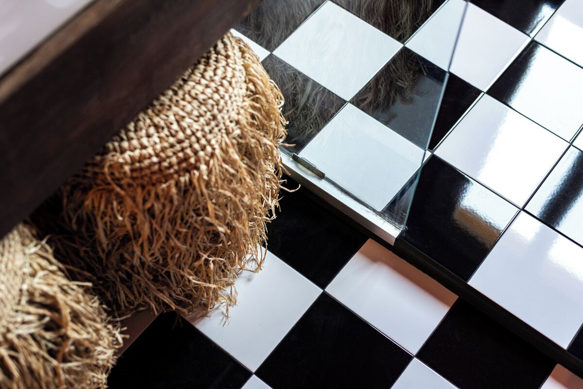 A checkered floor pattern with a woven basket.