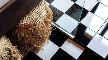 A checkered floor pattern with a woven basket.