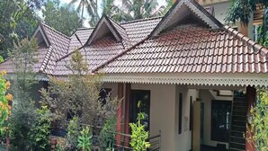 A traditional building with a tiled roof and a covered entrance.