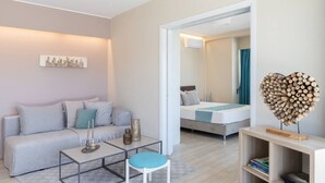 A modern, well-lit bedroom with a bed, bedside table, and a unique wooden heart-shaped decoration. - 2BD Luxury Sea View Penthouse in Astir Beach (Vouliagmeni)
