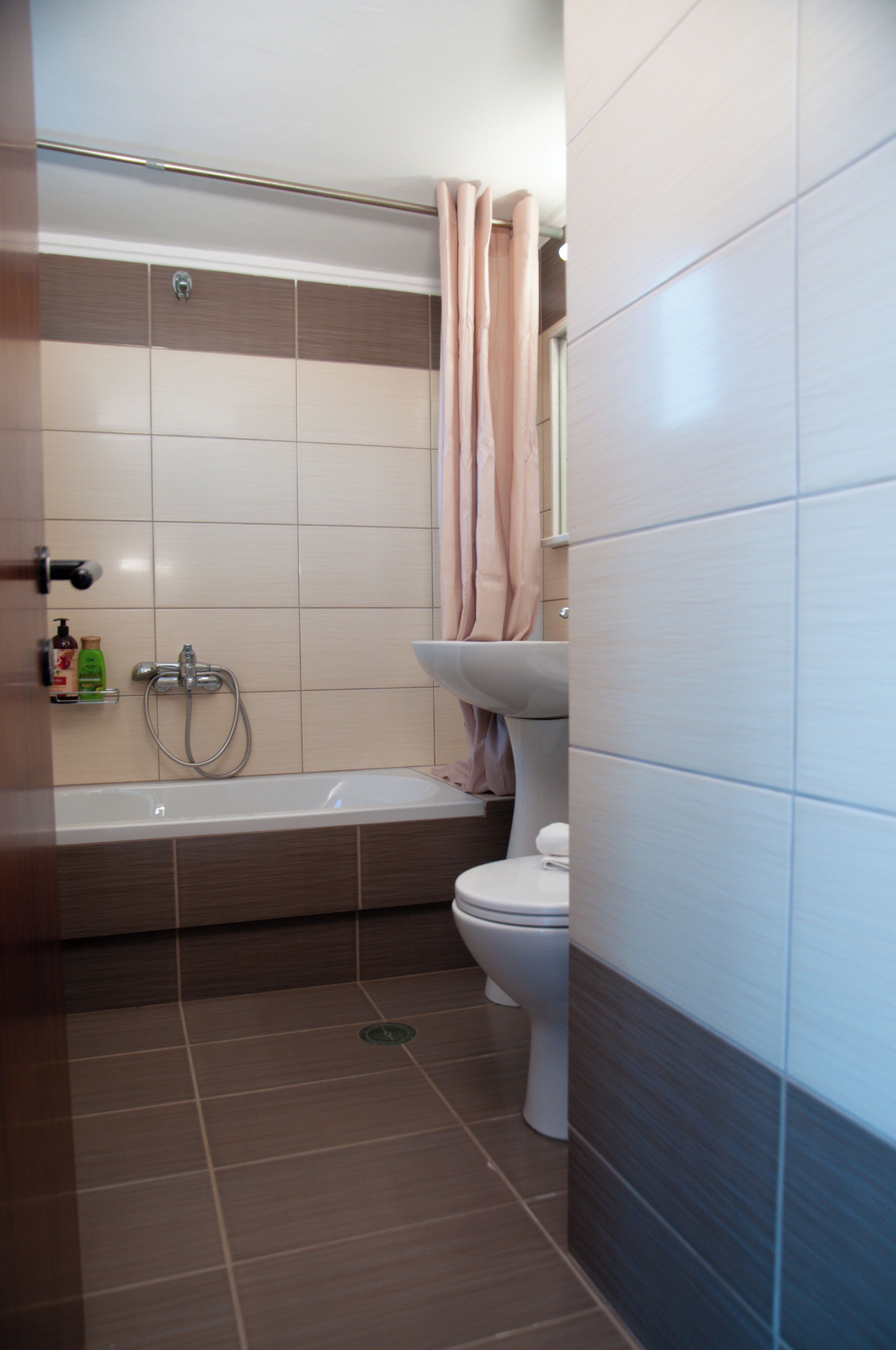 Un baño con bañera, inodoro y zona de ducha.