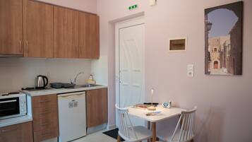 A compact kitchen with wooden cabinets, a built-in oven, and a small sink.