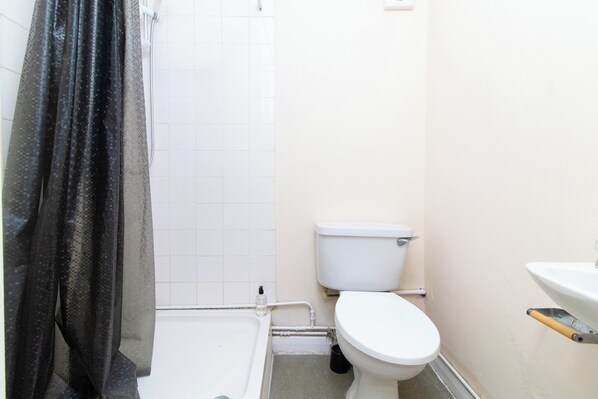A small bathroom with a toilet, sink, and bathtub.