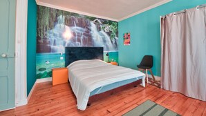 A bedroom with a bed, a mural of a waterfall, a wooden floor, a chair, and a curtain. - House for 8 in the center of Plouguerneau (Plouguerneau)