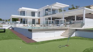 A modern two-story house with a swimming pool, outdoor seating, and a well-maintained lawn. - Villa Élan (Playa Paraiso)