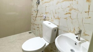 Ein Badezimmer mit Toilette, Waschbecken und Dusche.
