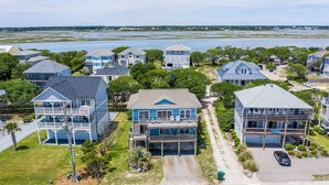 A coastal residential area with houses featuring balconies and waterfront views.