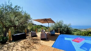A wooden deck with a pool, outdoor furniture, and a view of the sea. - Tenute Lomasi - near Cefalù with swimming pool (Lascari)