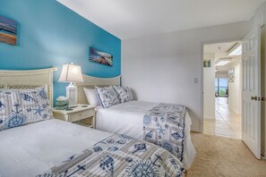A bedroom with two beds, a nightstand, a lamp, and a painting on the wall. - **2 bed, 2 bath Direct Gulf Front Unit at The Shores**Stunning Views** (Redington Shores)
