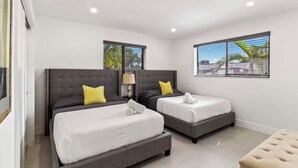 A hotel room with two beds, a small table, and a window with blinds. - Home 6 Mi to Hollywood Beach: Grill, Swim, Relax (Hollywood)