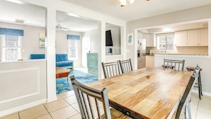 A spacious dining area with a large wooden table, chairs, and a ceiling fan. - Walk to Ocean & Golf: North Myrtle Beach Home! (North Myrtle Beach)