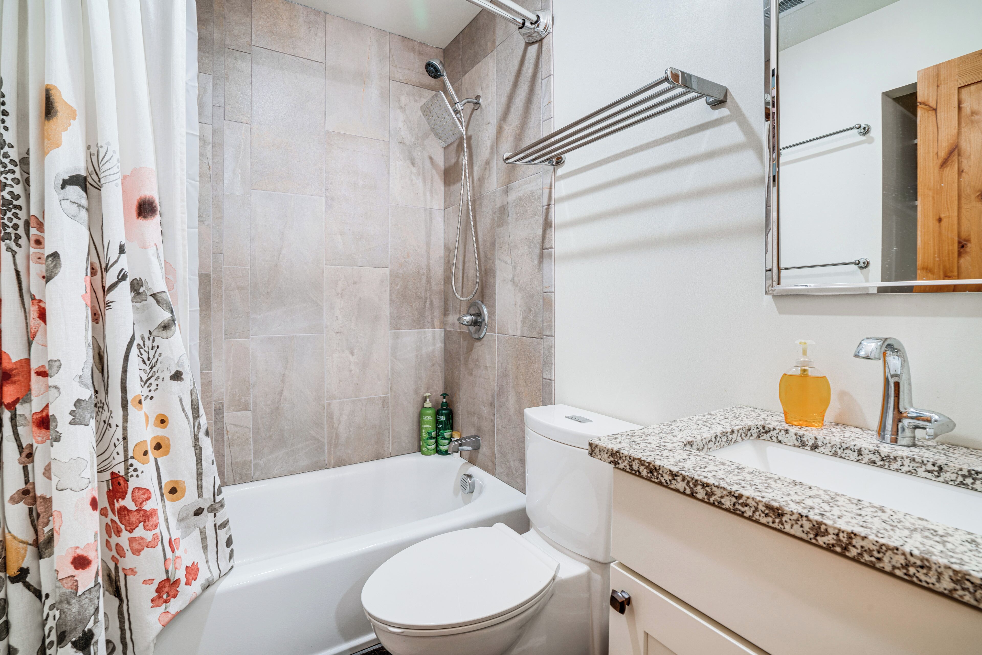 A bathroom with a bathtub, toilet, and sink.