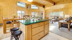A wooden cabin interior with a kitchen, dining area, and living room. - Walk to Sinks Canyon State Park: Spacious Home! (Lander)