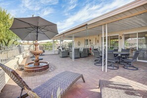 A covered patio with outdoor furniture, a fountain, and a pergola. - Walk to Golf Course: Sun City West Retreat (Sun City West)