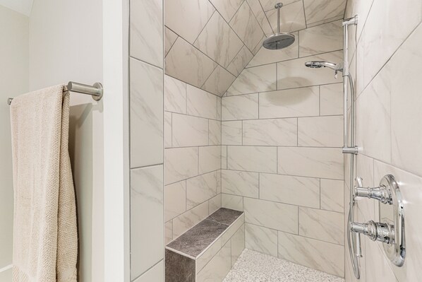 A modern shower with a handheld showerhead and a wall-mounted faucet. - Farm On-site: Mtn-view Cottage in Hendersonville! (Hendersonville)