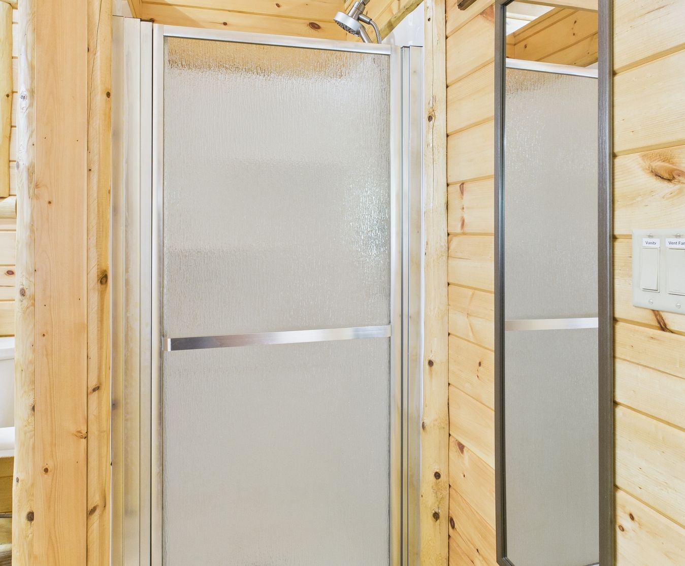 A wooden interior with a shower enclosure.