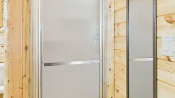 A wooden interior with a shower enclosure.
