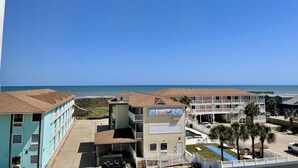 A beachfront hotel with multiple buildings, including a prominent 'Beach Gate' sign, a pool, and a parking area. - Beachgate Condo Suites And Hotel 331+332 4 Bedroom Condo (Port Aransas)