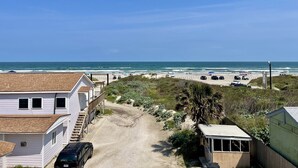 A coastal road leading to a beach with a white house and a small shed. - Beachgate Condo Suites And Hotel 237+238+239 3 Bedroom Condo (Port Aransas)