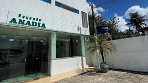 A building with a sign reading "Pousada ANADIA" and a palm tree in the foreground. - Pousada Anadia (Anadia)