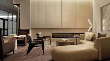 A modern living room with a sectional sofa, a coffee table, and a fireplace.