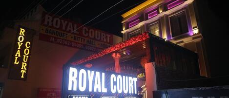 A building with a prominent "ROYAL COURT" sign, indicating it is a hotel or similar establishment.