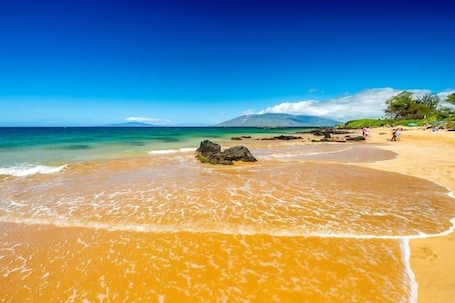 On the beach, sun-loungers, beach towels. *Beach* KingBd * Resort * Pool * Adult Hot Tub *