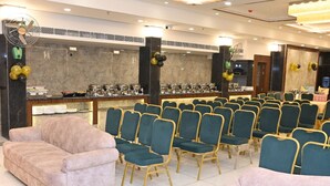 A banquet hall with rows of chairs and a buffet area. - HOTEL KRISHNA PARADISE (Agra)