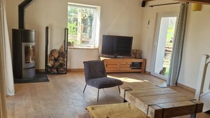 A cozy living room with a fireplace, a television, and a comfortable seating area. - Mas Crudel - Character house in the South of France (Parisot)