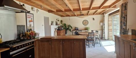Enjoy cooking in this well-equipped kitchen with a central island, stove, and ample dining space.