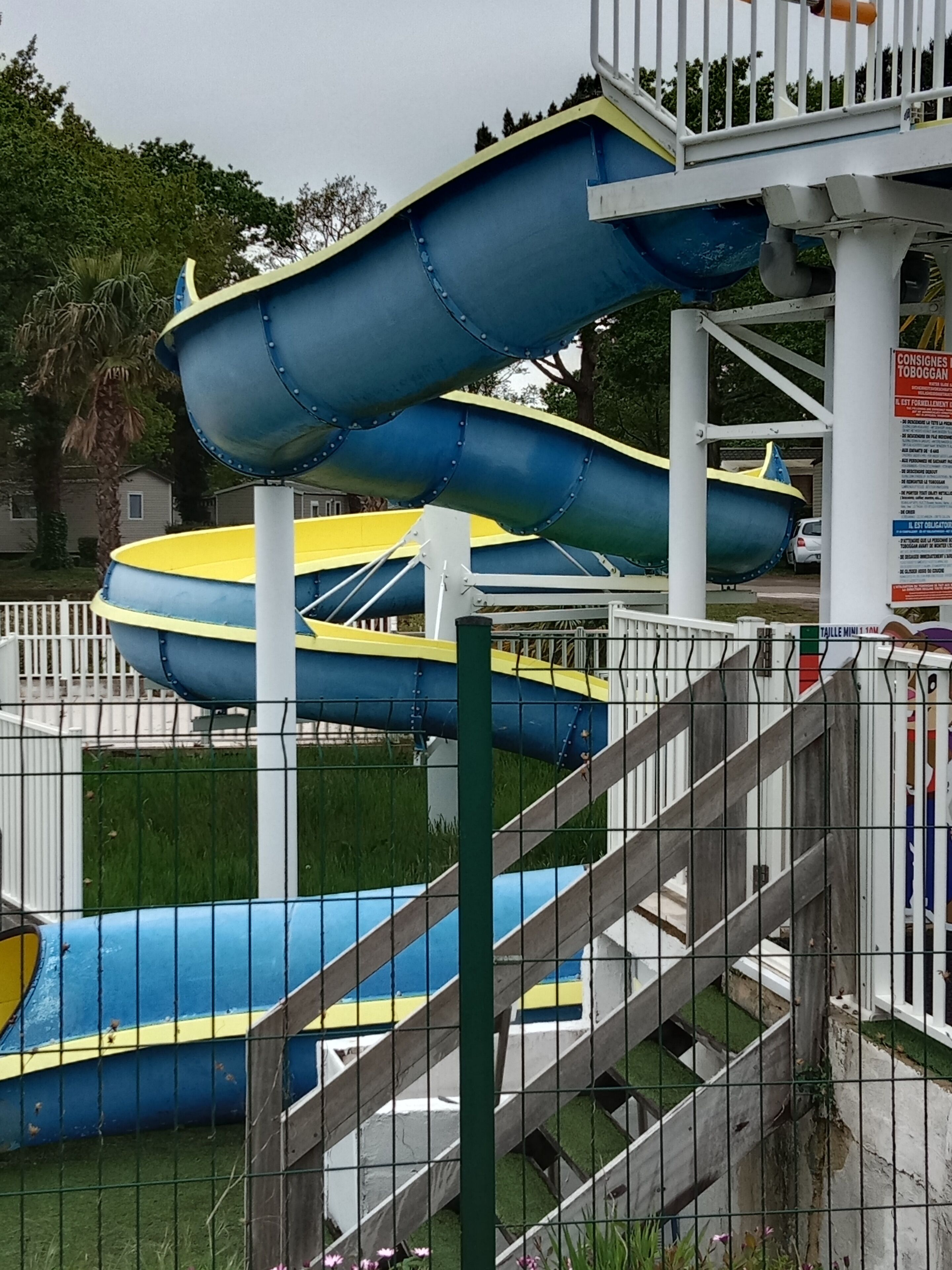 A water park with multiple slides and a fenced area.