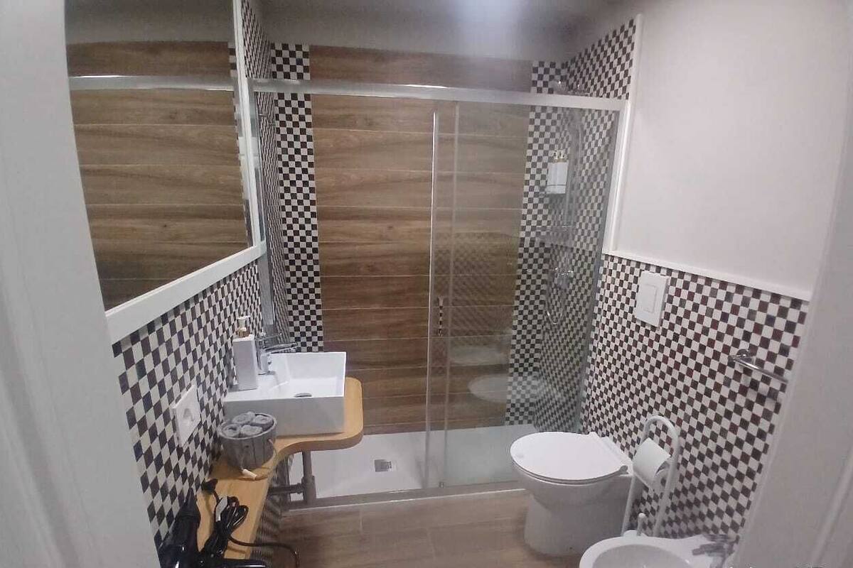 Shower, hair dryer, slippers, towels