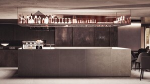 A modern bar area with a long counter, bar stools, and a variety of bottles and glasses. - Thirty Three Boutique -Adults Only By K Hotels (St. Julian's)