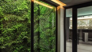 A modern interior with a glass wall featuring a lush green vertical garden. - Thirty Three Boutique -Adults Only By K Hotels (St. Julian's)