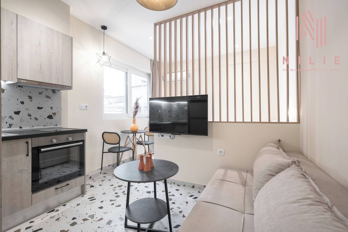A compact living space with a kitchenette, a dining area, and a seating area.