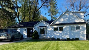 A two-story house with a well-maintained lawn, a driveway, and a parked SUV. - Darling Bungalow in the heart of quaint Inglewood, On. 15 minutes from Osprey! (Inglewood)