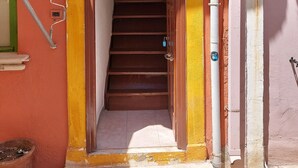 A staircase leading to a door with a number 47 sign above it. - Fortezza Nest - Old Town Rethymno (Rethymno)