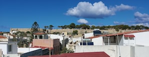 A residential area with houses, satellite dishes, and a prominent 'FALCON' sign. - Fortezza Nest - Old Town Rethymno (Rethymno)