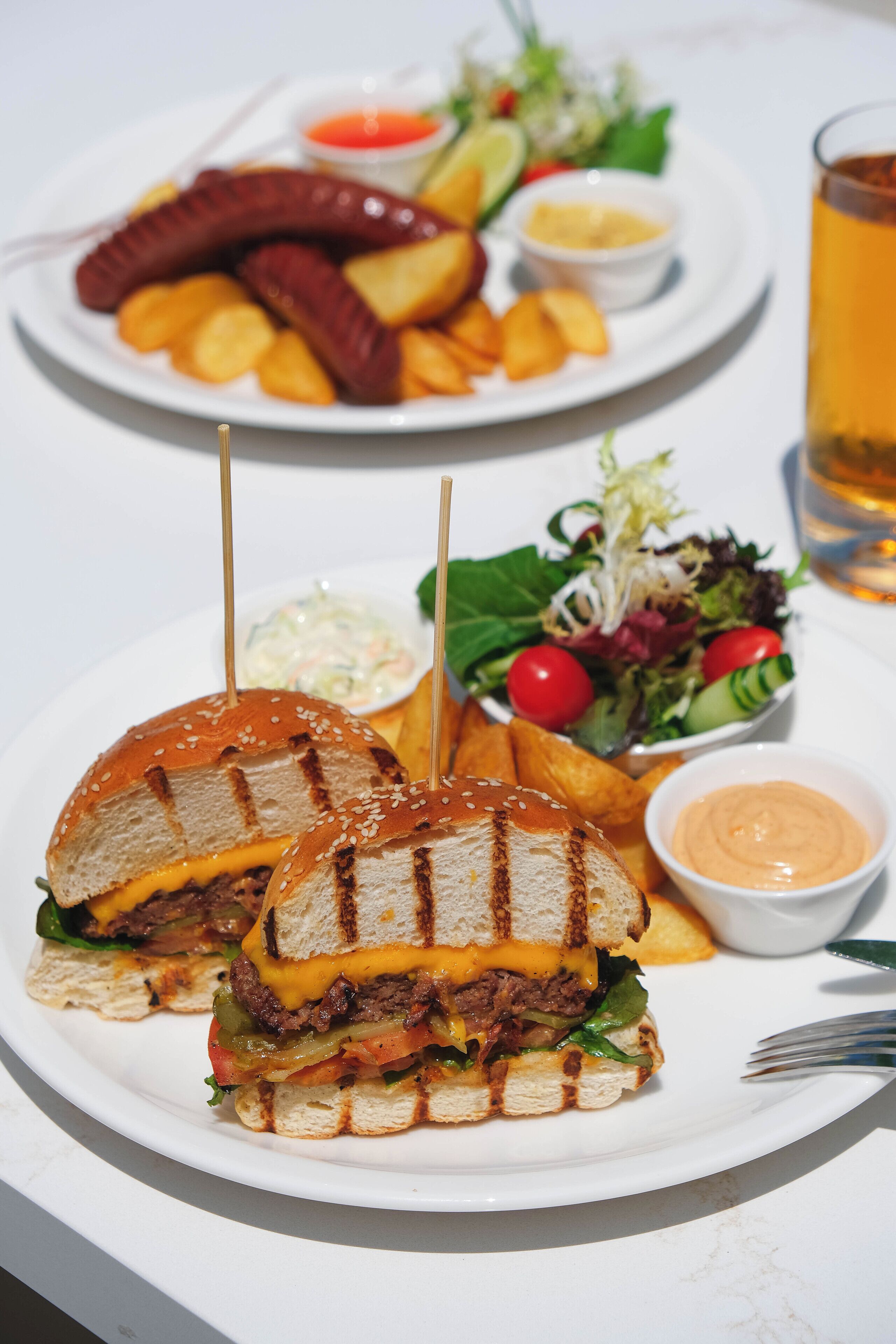 A plate with a grilled sandwich, fries, and a salad.