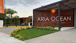 A modern building with the name "ARIA OCEAN" prominently displayed on the facade.
